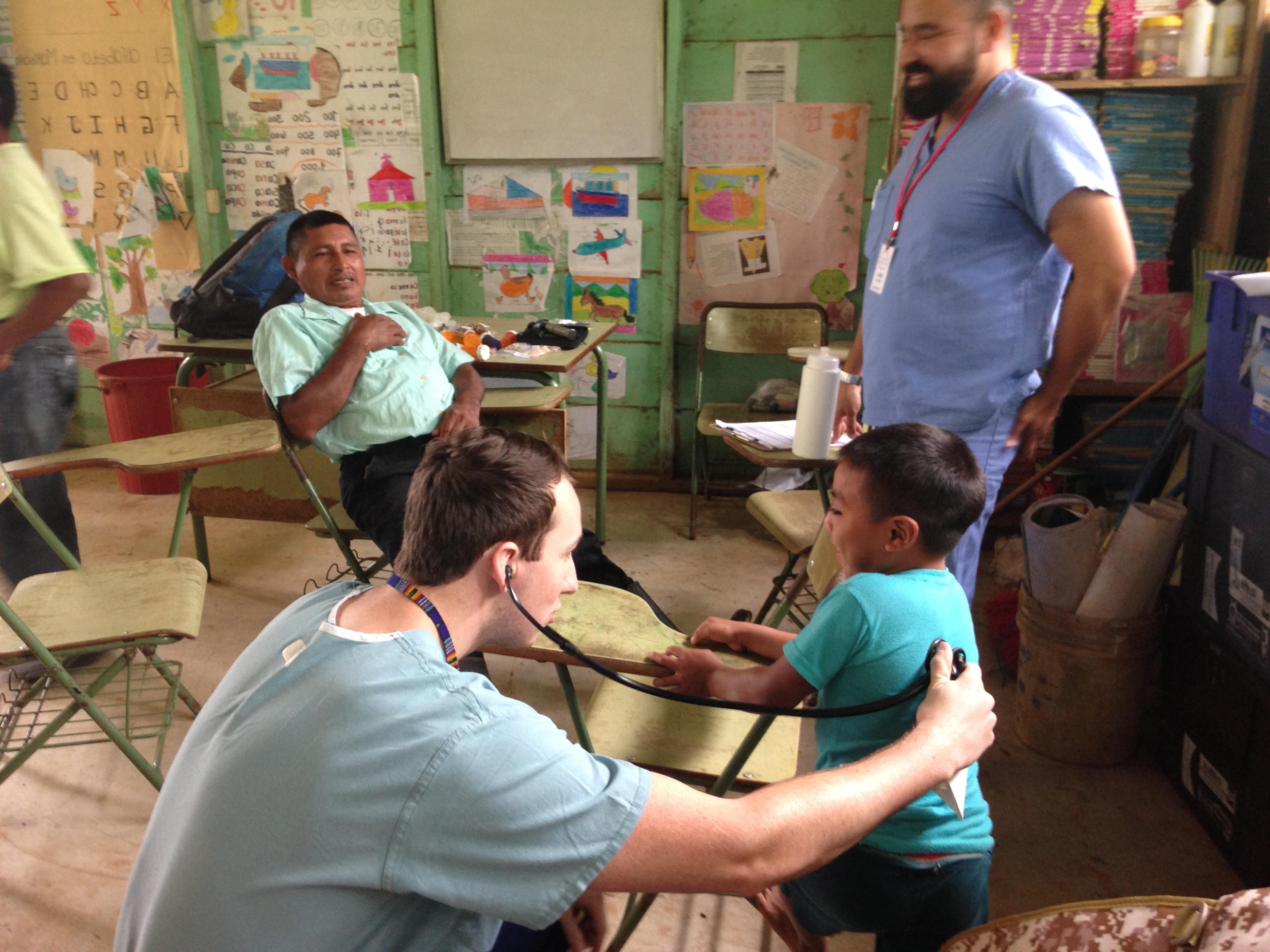 PA student providing care to child in Guatemala
